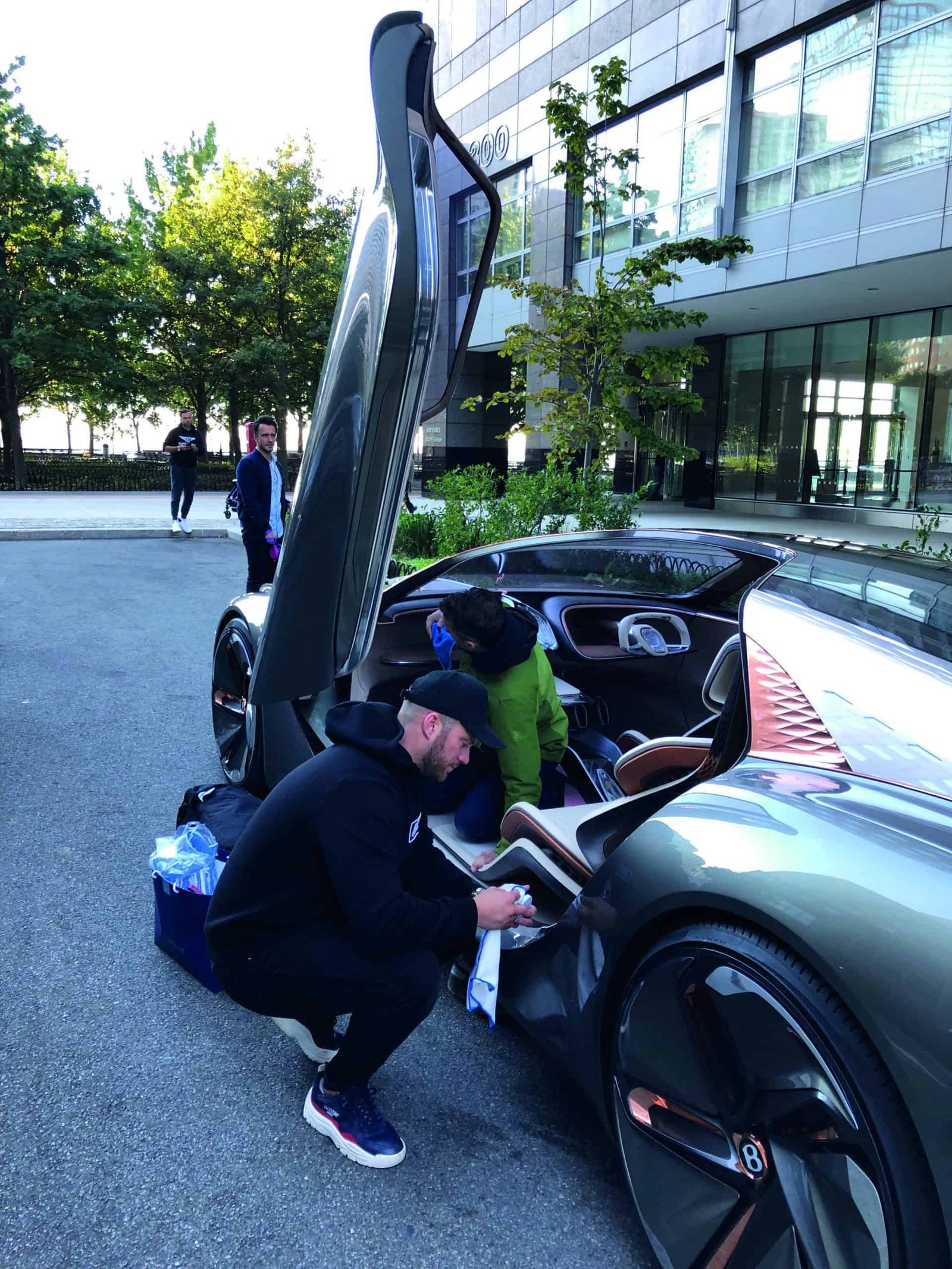 In this scene, a man is engaging in an endless experiment as he opens the door of a car.