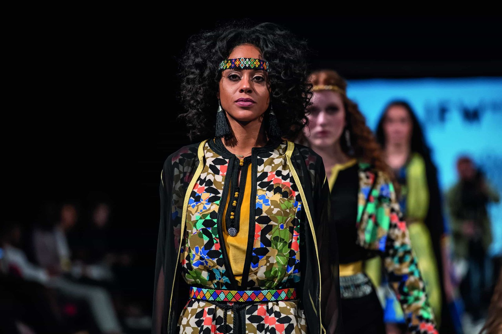 A model made down the runway in a colorful outfit.