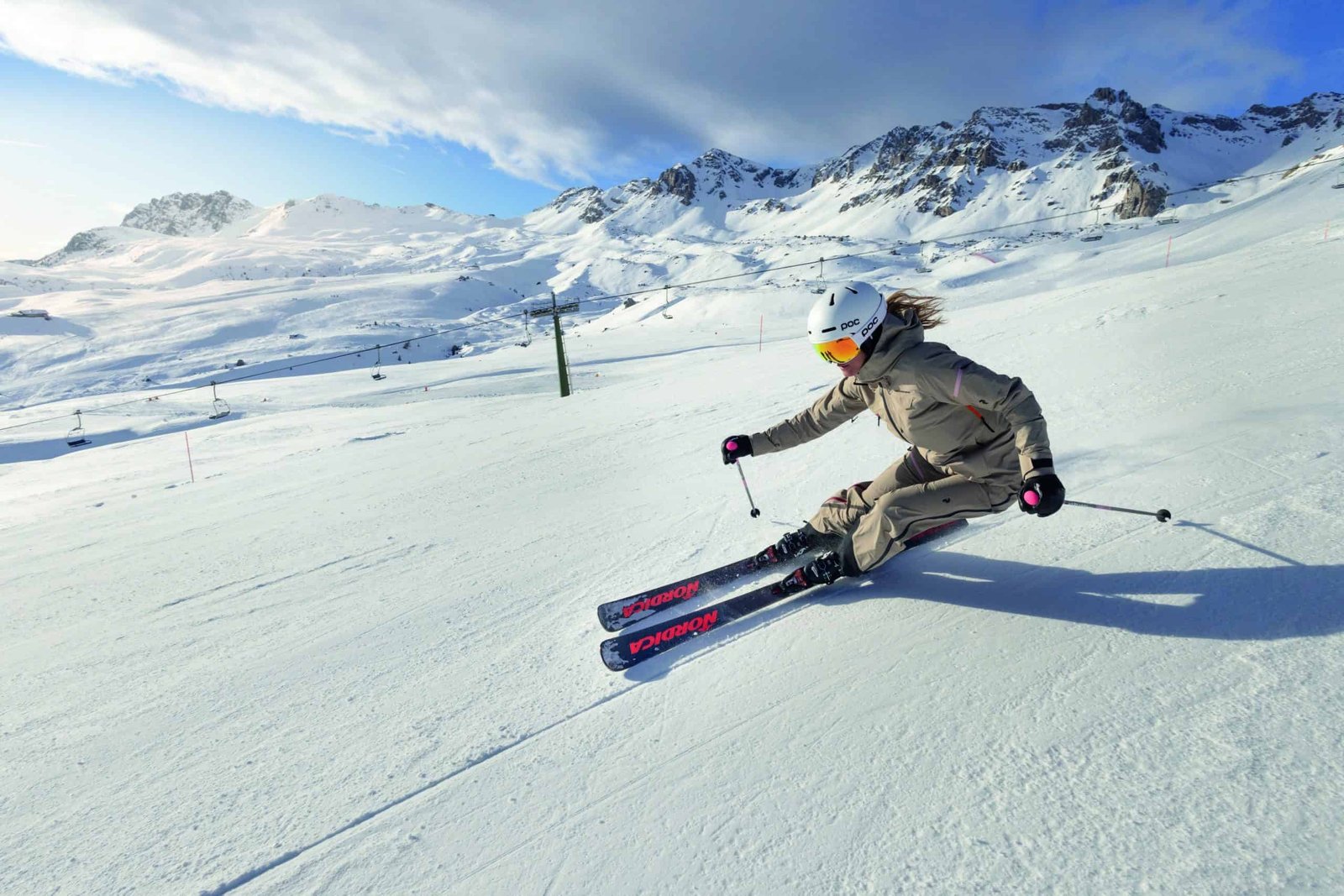 The best skier glides down the snowy slope effortlessly on one foot.