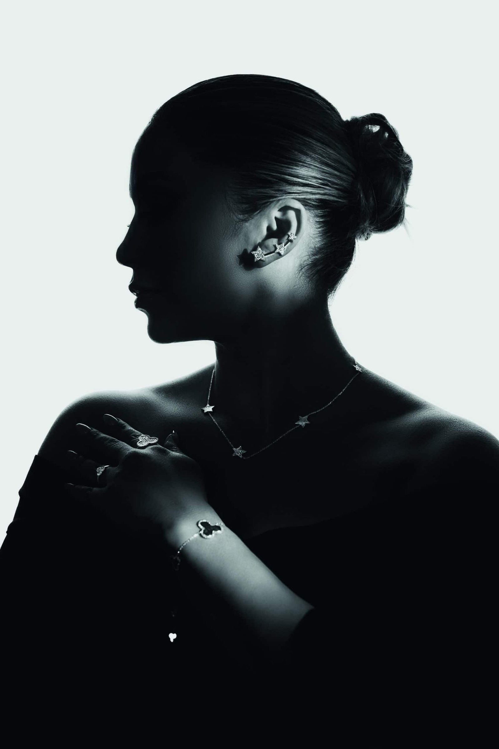 A futuristic silhouette of a woman adorned with diamonds.