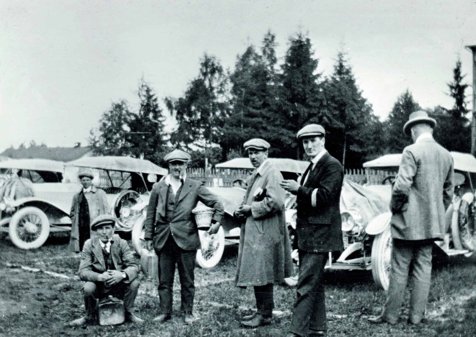 A group of men standing next to a trial of the century.