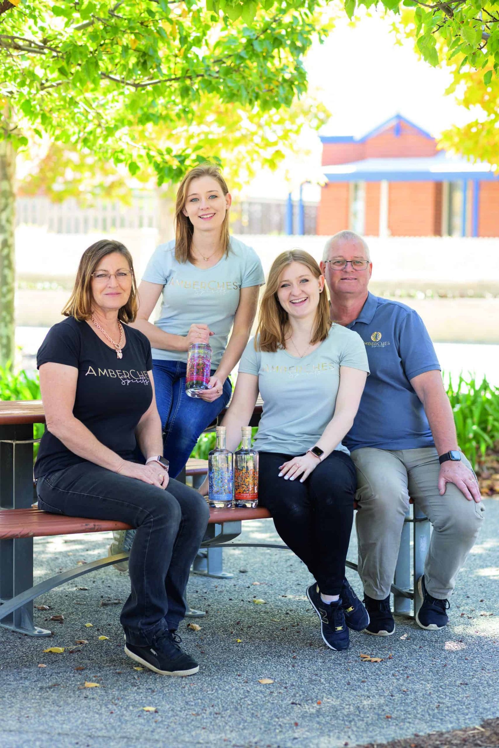 A family sitting on a bench.