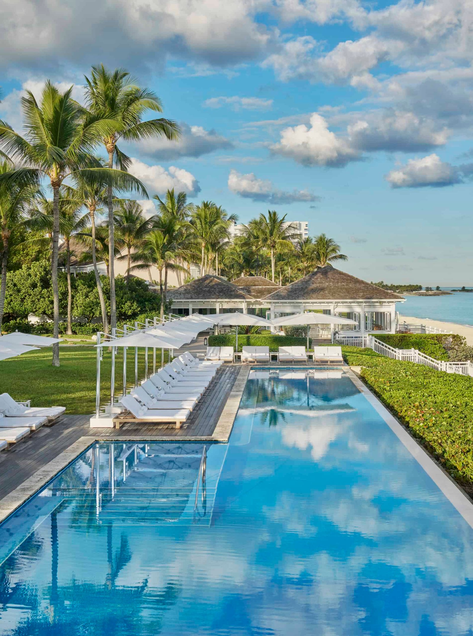 A Caribbean swimming pool with lounge chairs and palm trees, where you can discover a hidden treasure.