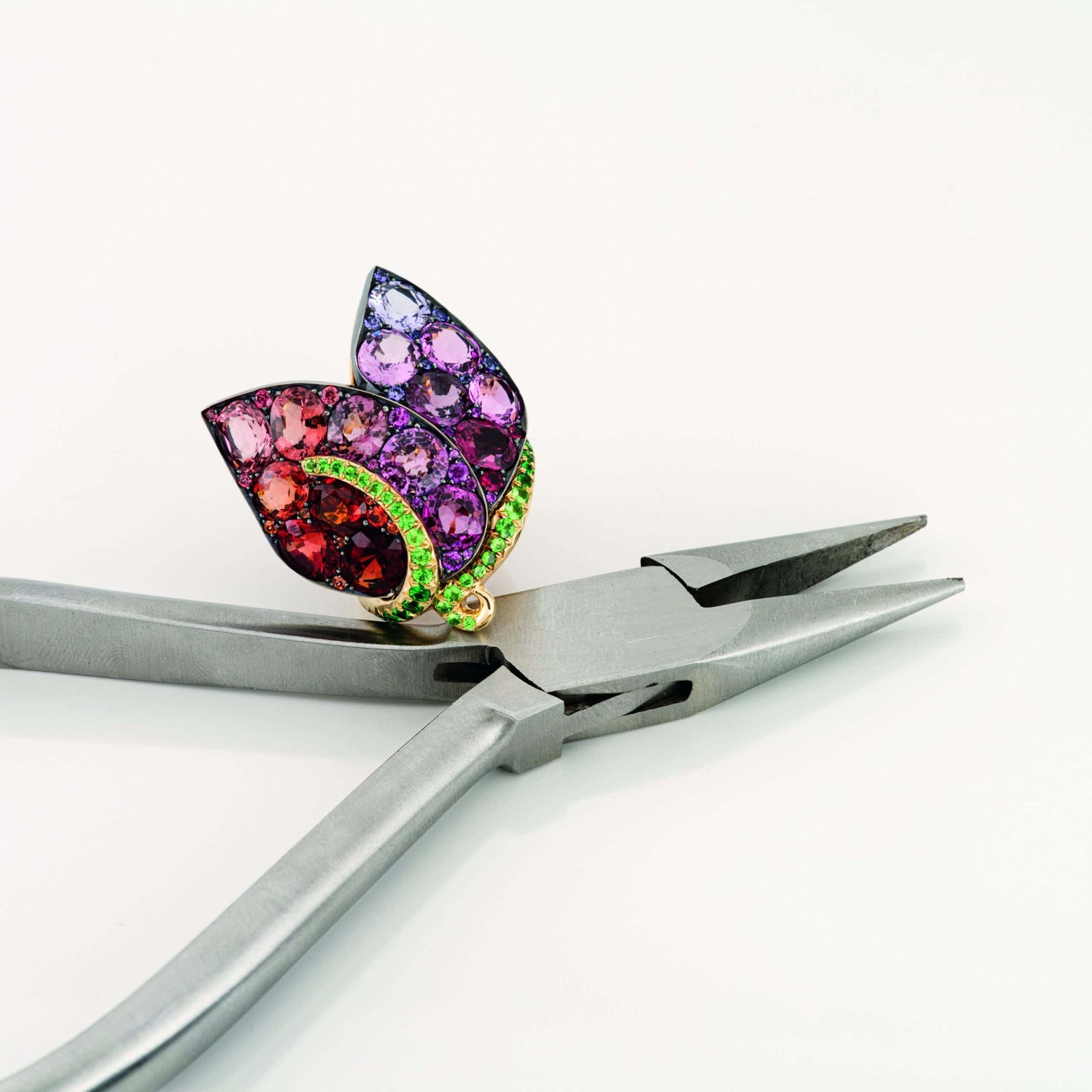 An artistic pair of pliers adorned with a colorful flower, exhibiting creative flair.