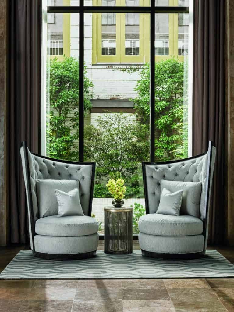 Two legacy chairs in front of a window.