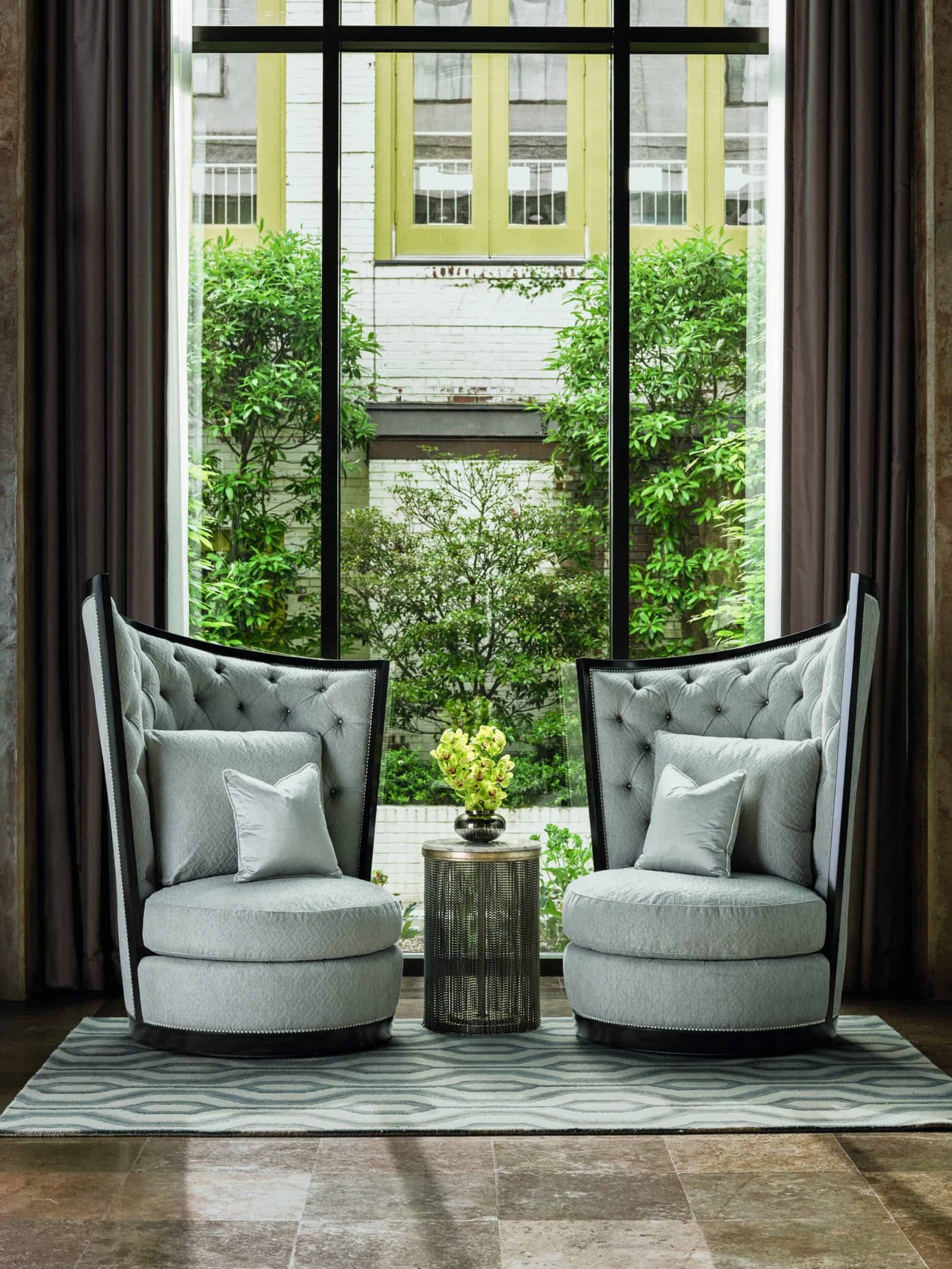 Two legacy chairs in front of a window.