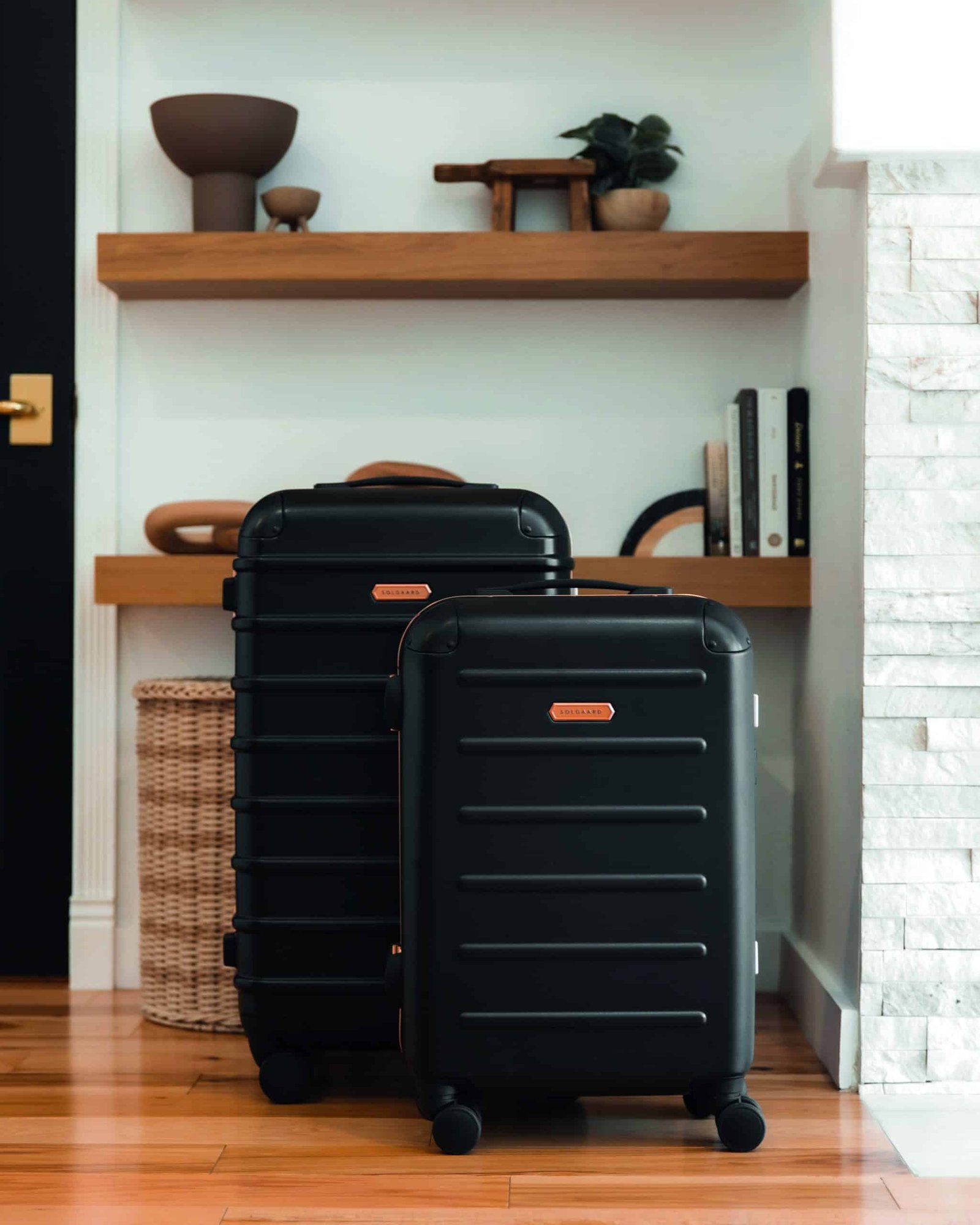 Two reimagined suitcases sitting in front of a wooden floor, ready for travel.
