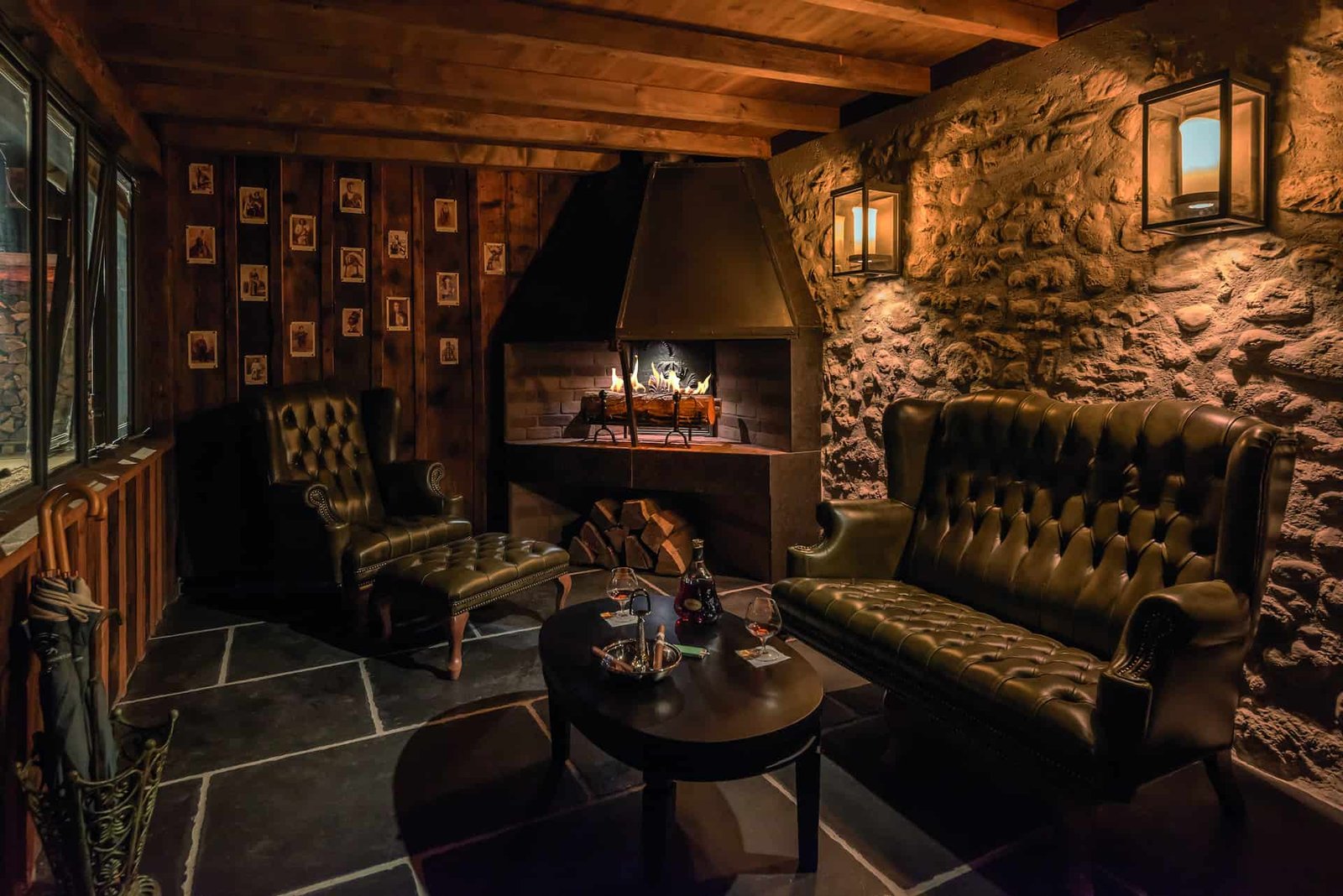 A captivating room in a dark castle adorned with leather furniture and a crackling fireplace.
