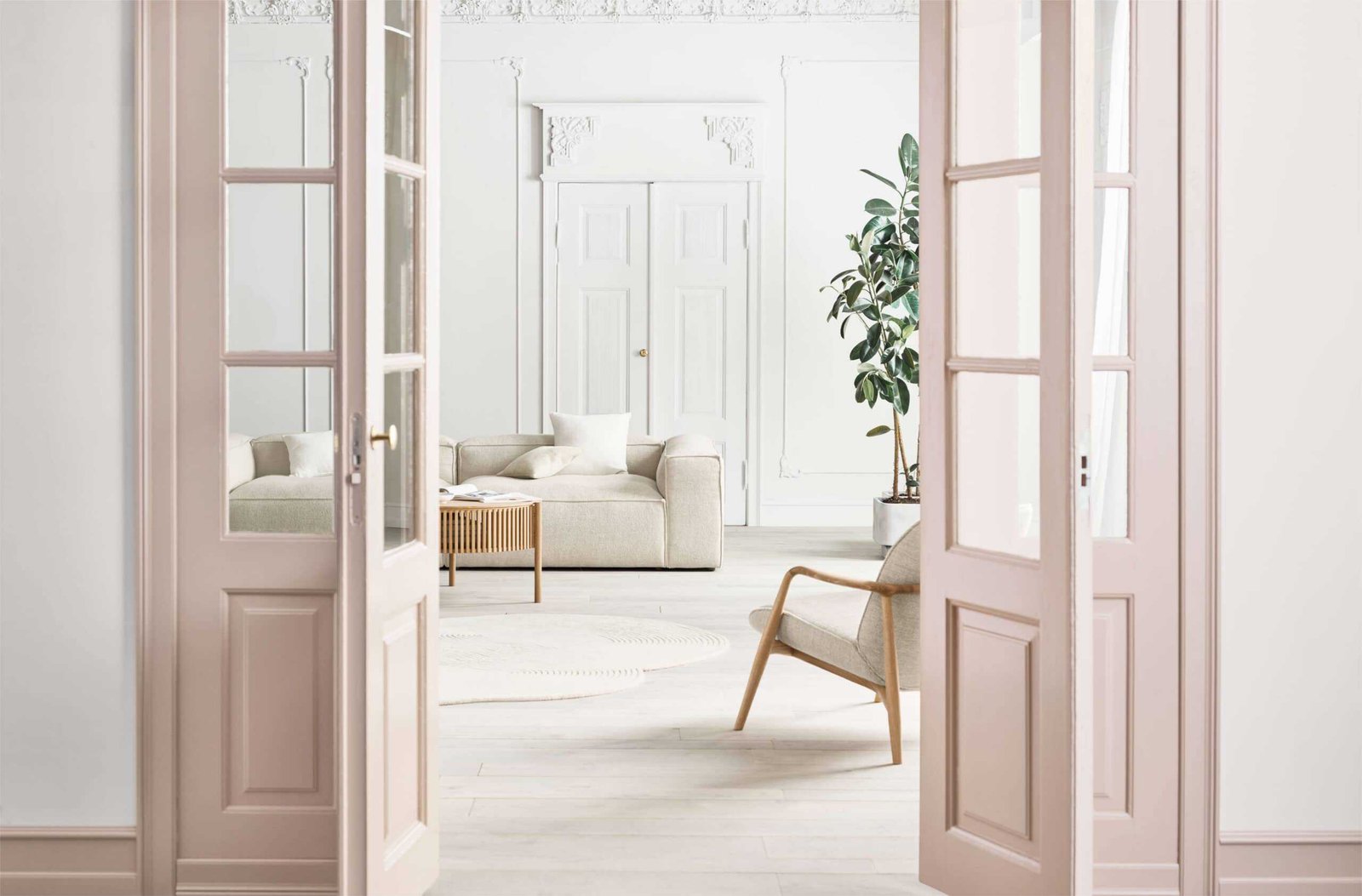 A luxury living room with a white couch and scandinavian design elements.