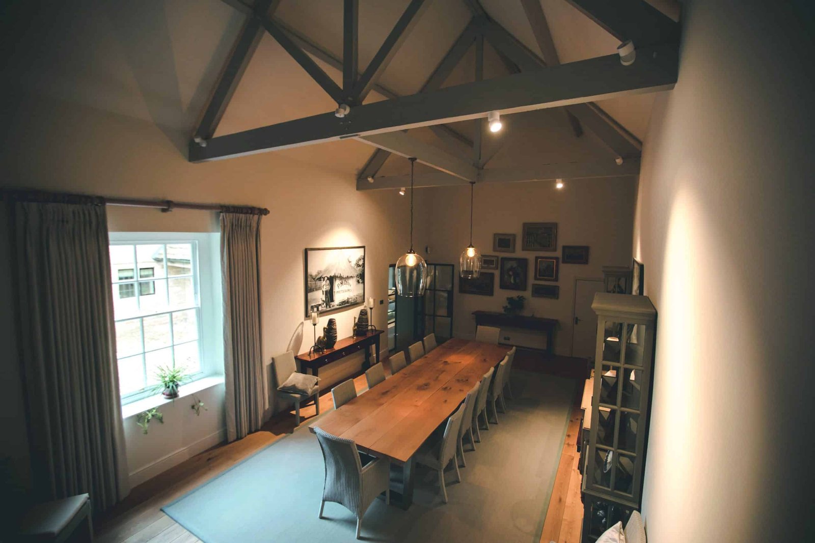 A dining room with a luminous wooden table and chairs.