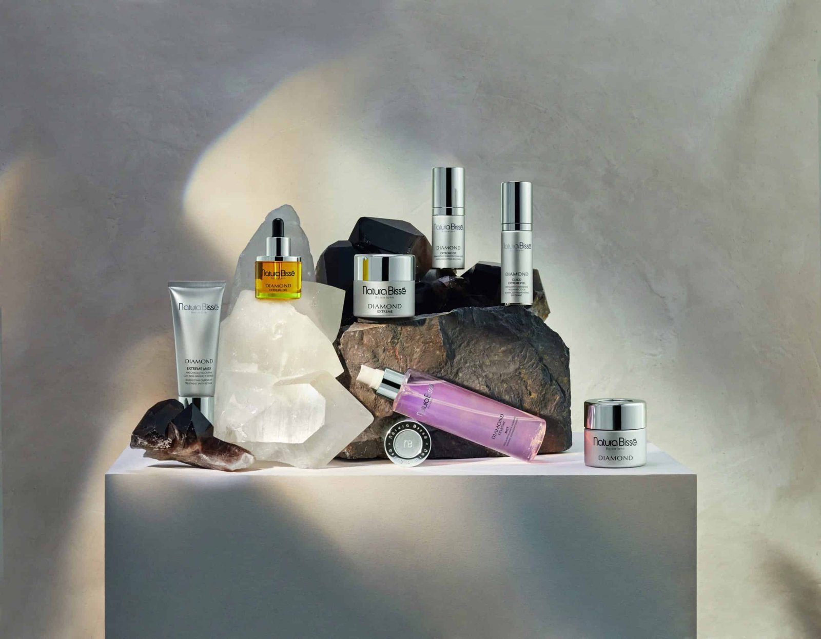 A collection of beauty products promoting a sense of wellbeing sitting on a rock.