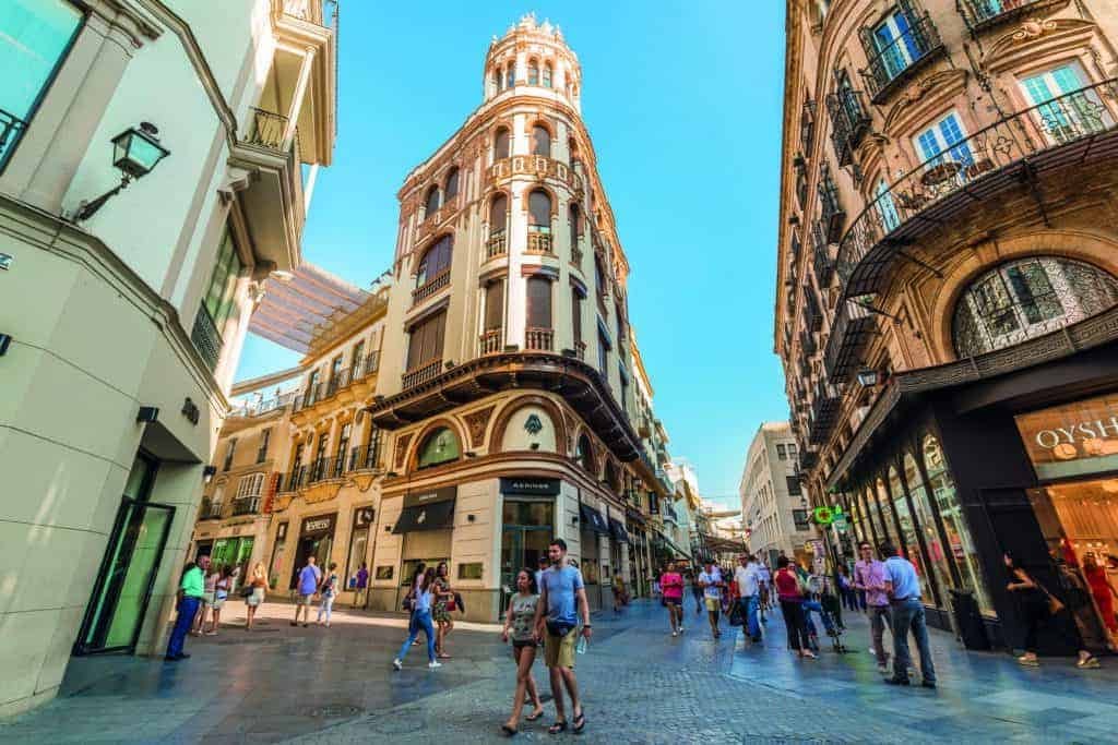 People walking down a street in Barcelona, España.