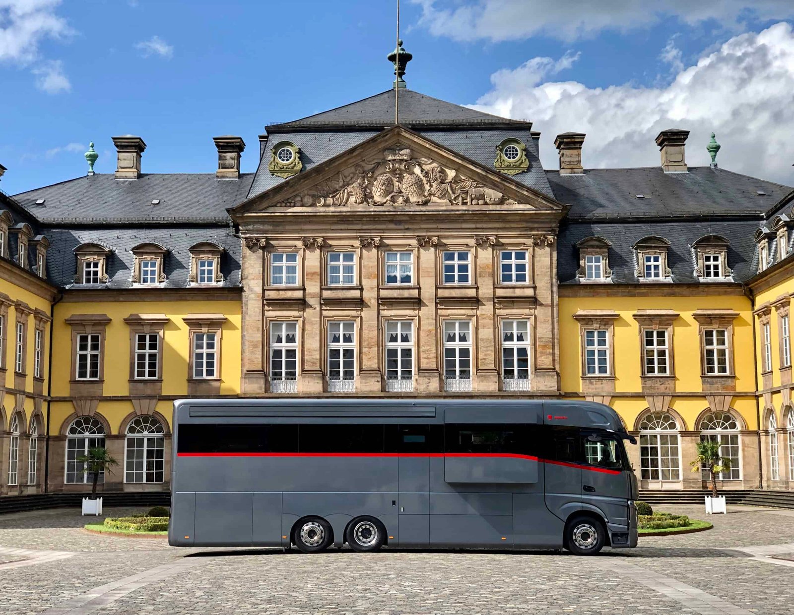 A high-end bus parked in front of a building.