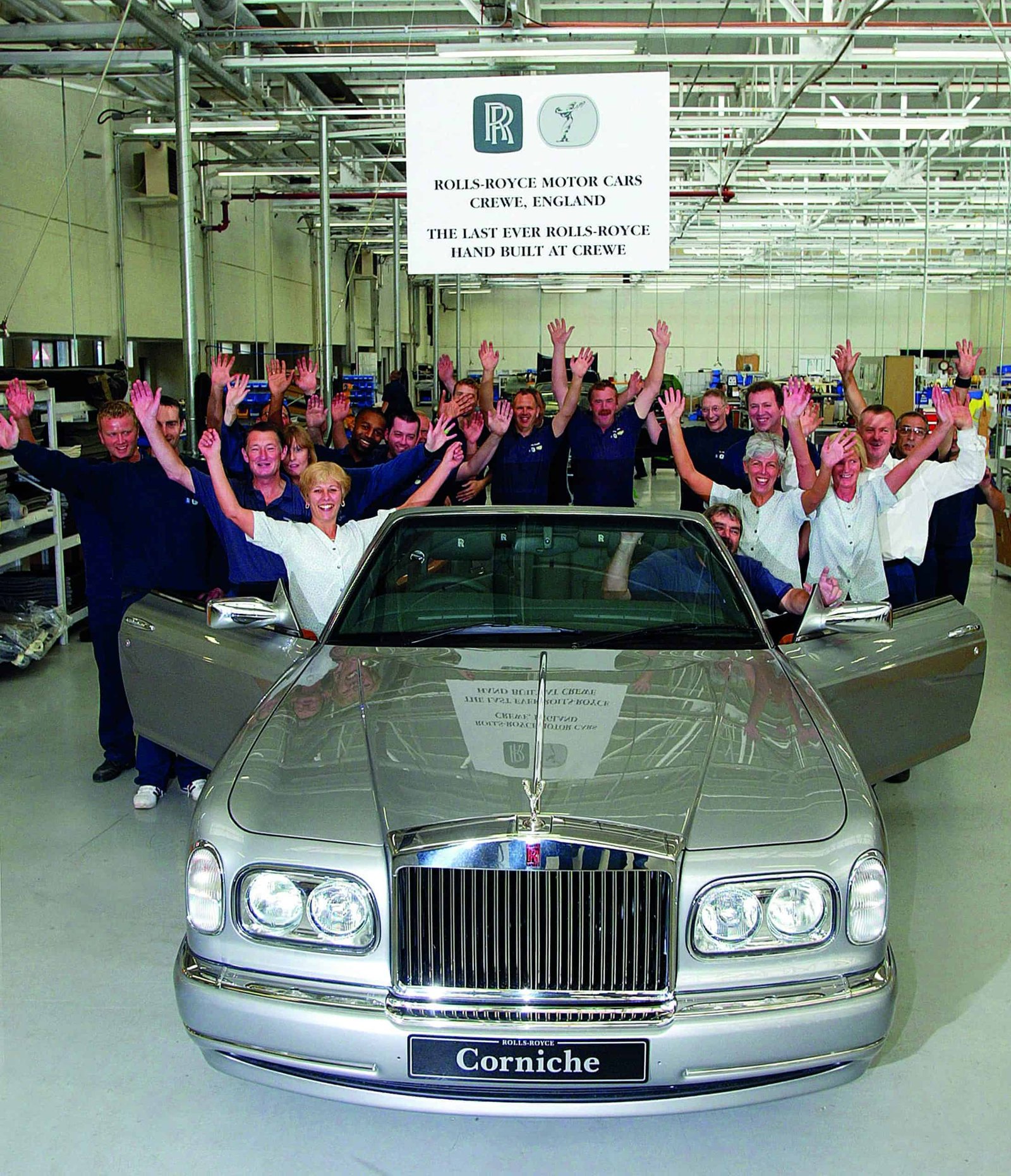 A silver rolls royce car.