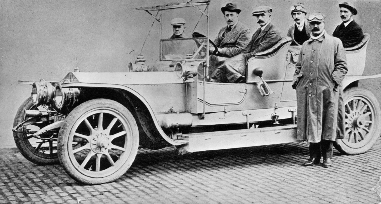 An innovative black and white photo capturing the spirit of a group of men in a car.