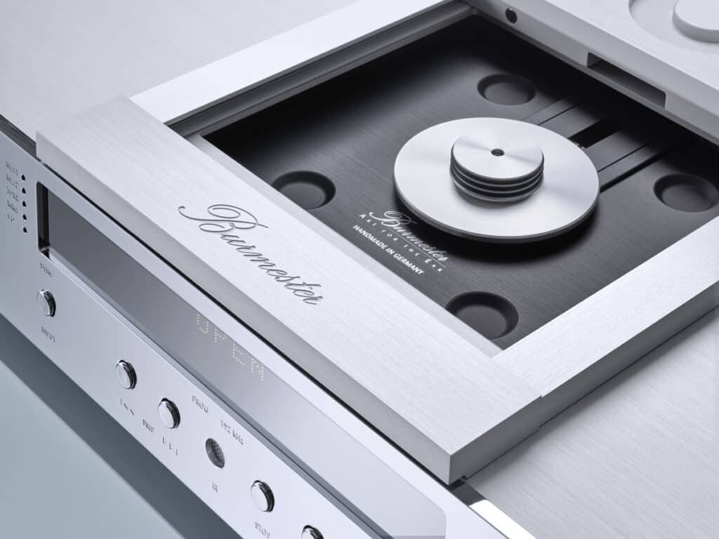A silver-colored CD player with a remote control that breaks sound barriers.