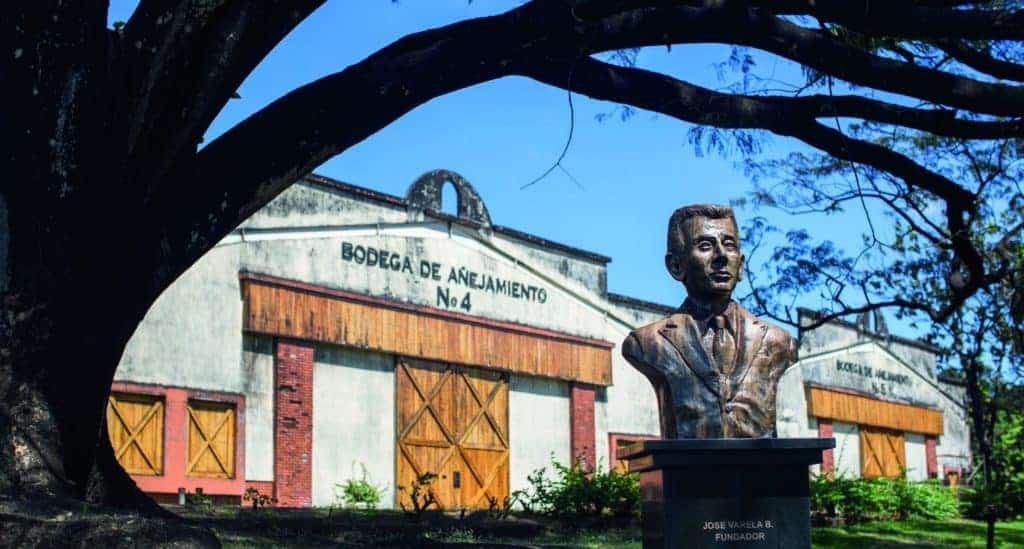 A punch-drunk man in front of a building.