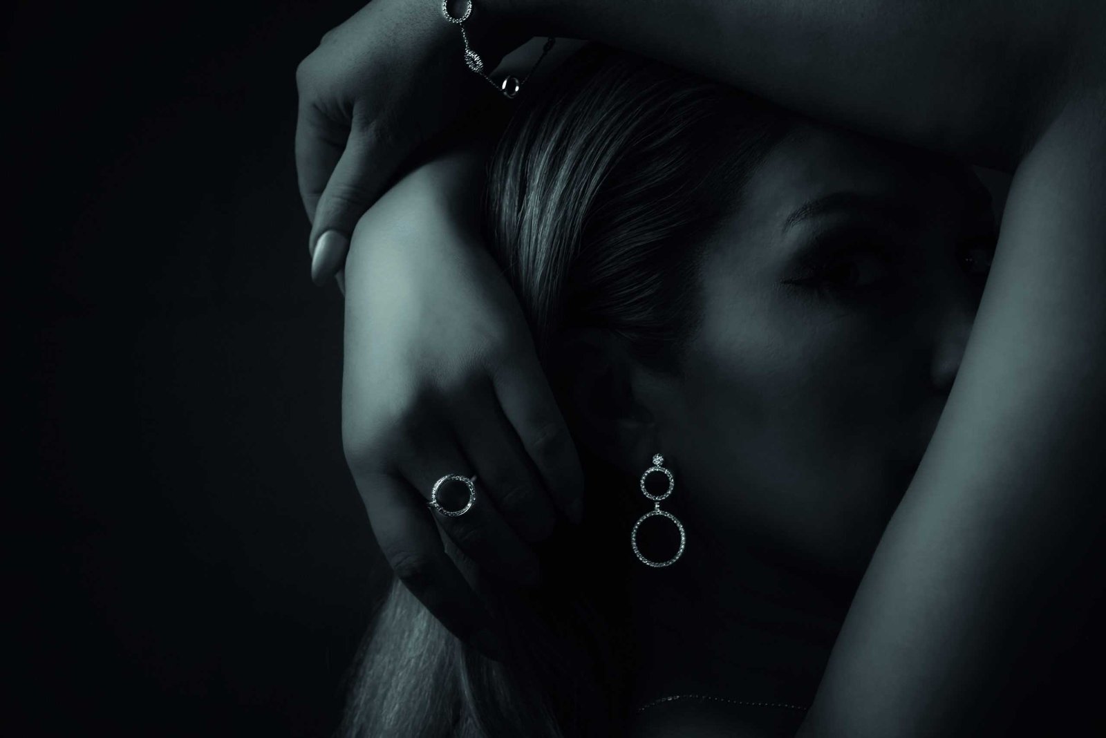 A black and white photo of a woman with a diamond ring on her hand, representing a future commitment.