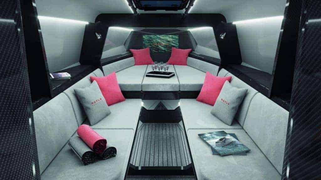 The interior of a bespoke luxury car with pink pillows.