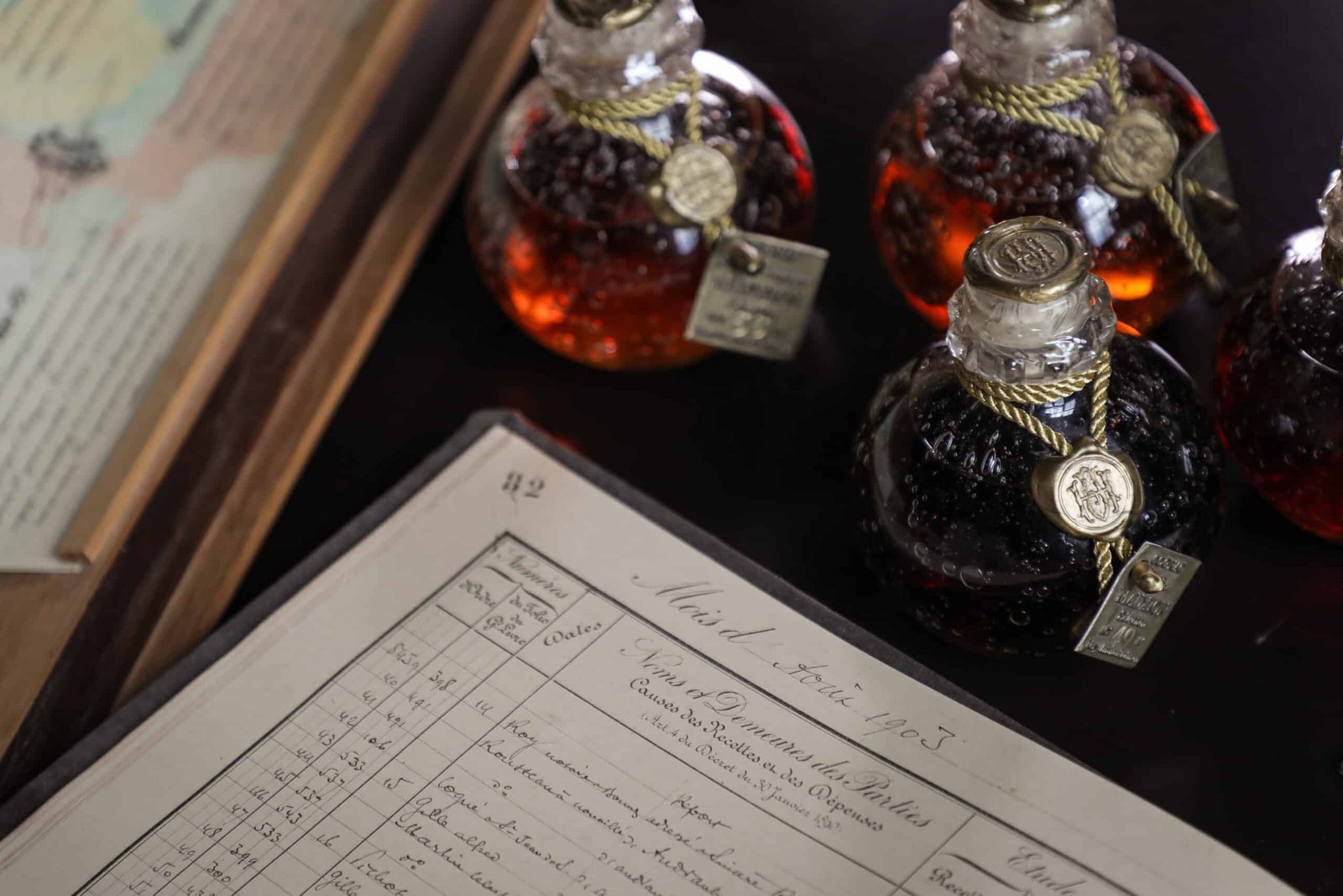 A fine bottle of bourbon sits on a table next to a map.