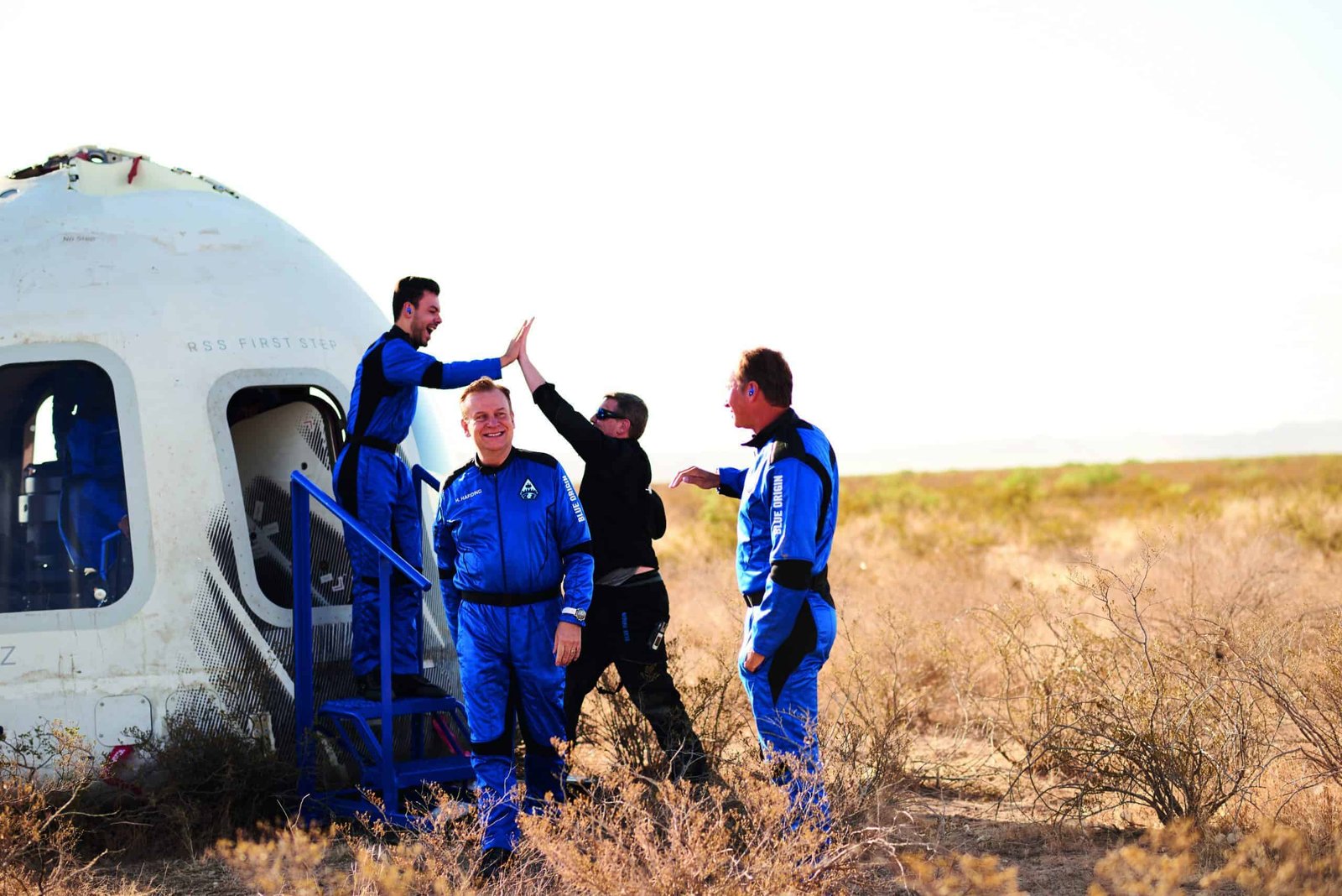 A group of pioneers standing next to an aviation spacecraft.