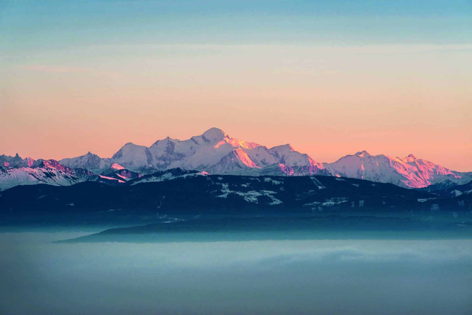 Sunrise over the snow capped mountains in the Swiss Alps.