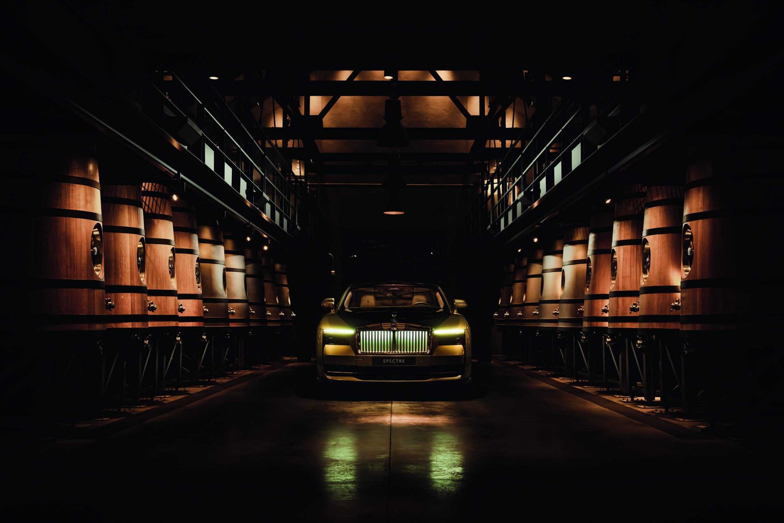 A Spectre rises silently in the darkness of a room, its luxurious Rolls Royce parked elegantly.