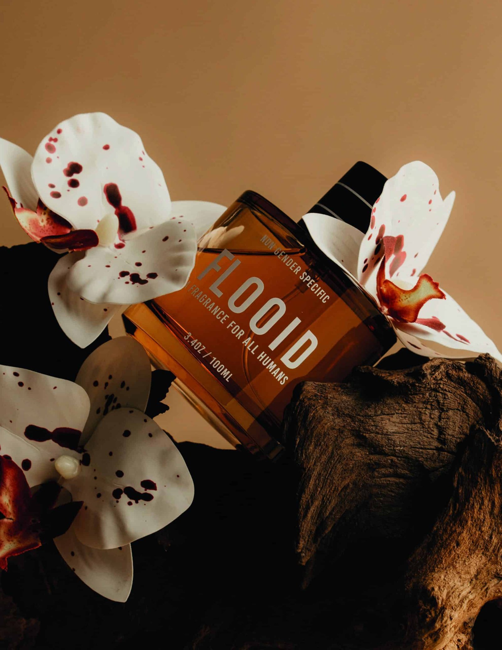 A bottle of perfume exuding alluring beauty as it rests gracefully atop a piece of wood.