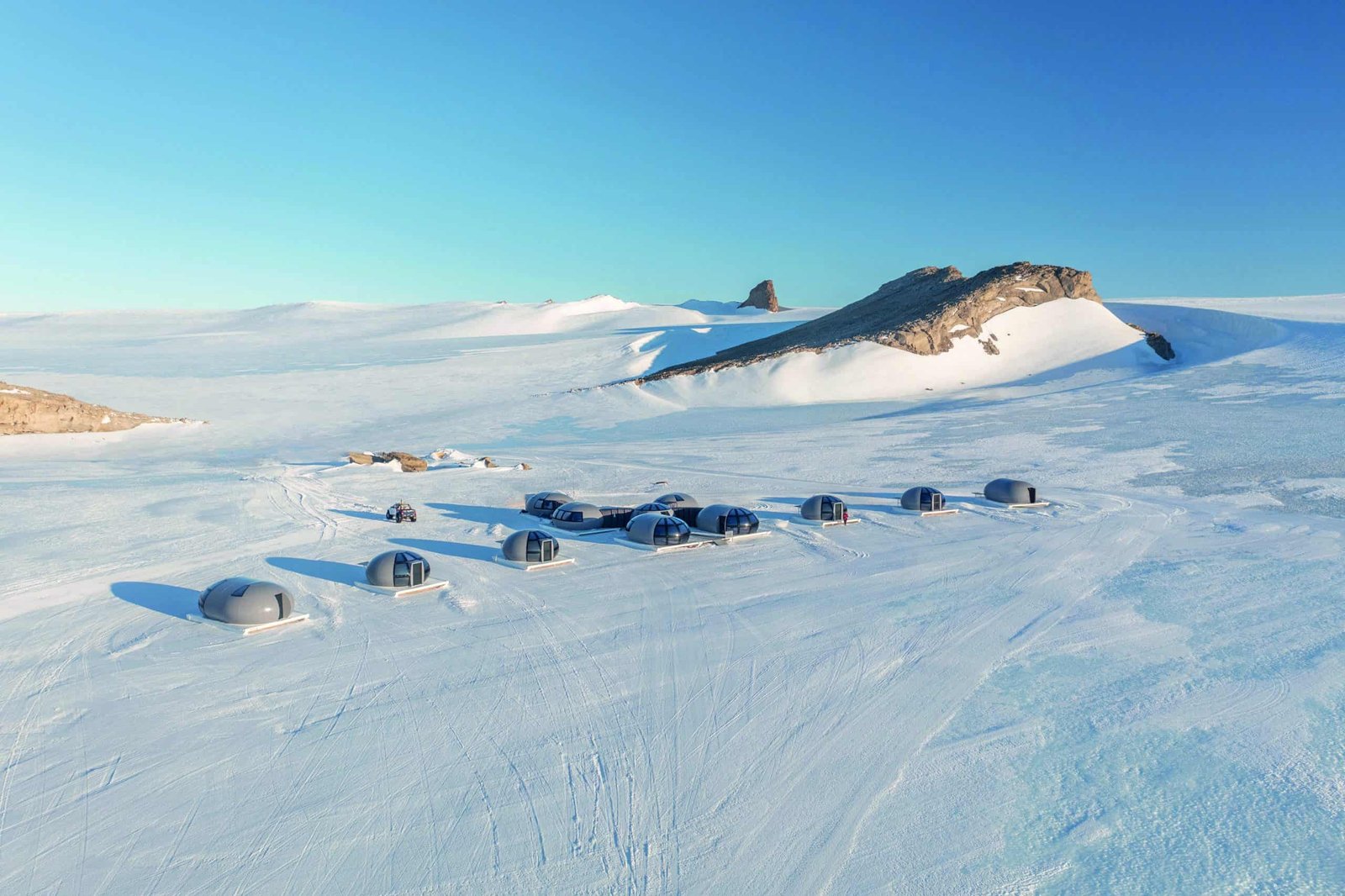 A group of tents on a snow covered field, providing the perfect setting for a lifetime trip.