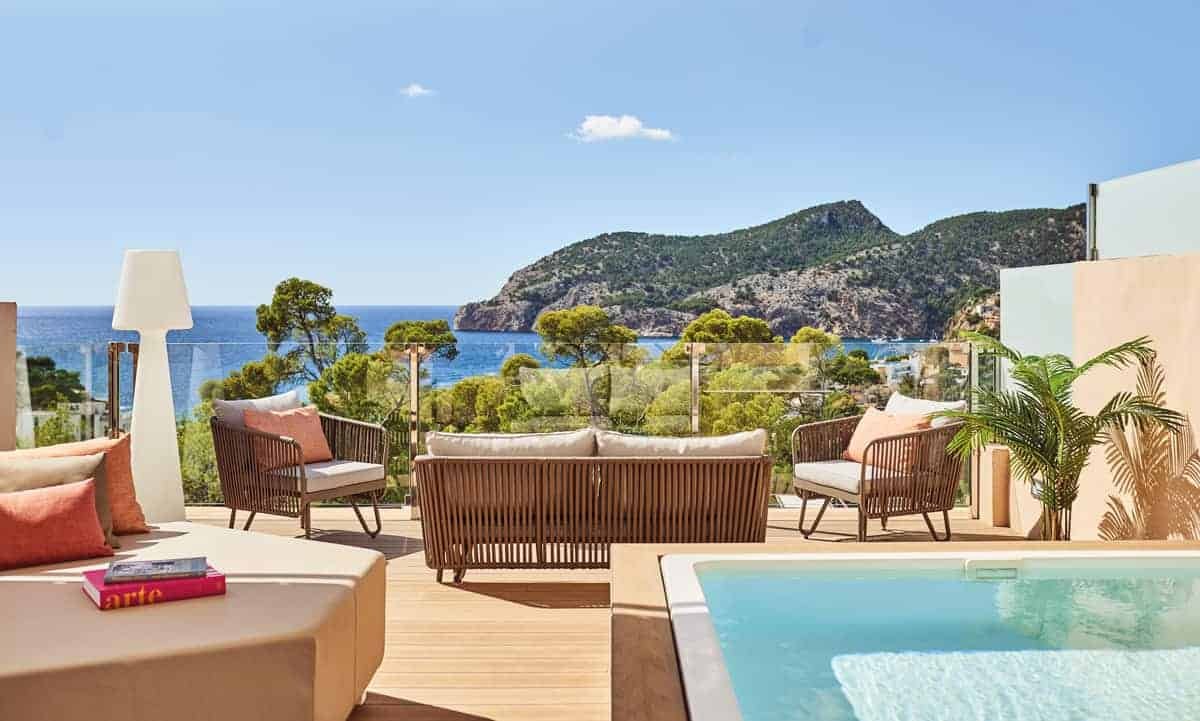 A redefining luxury stay with a swimming pool on a terrace overlooking the ocean.