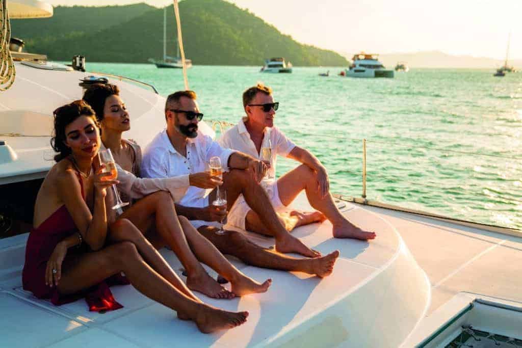 A group of friends sailing on the deck of a yacht.