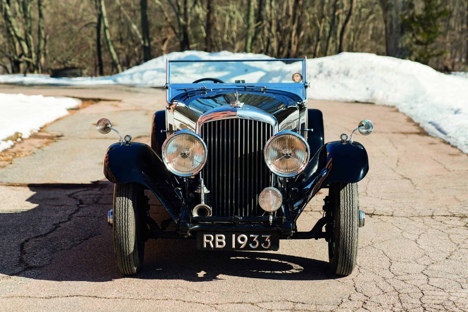 A vintage car is parked on a snowy road, combining the best of both worlds.