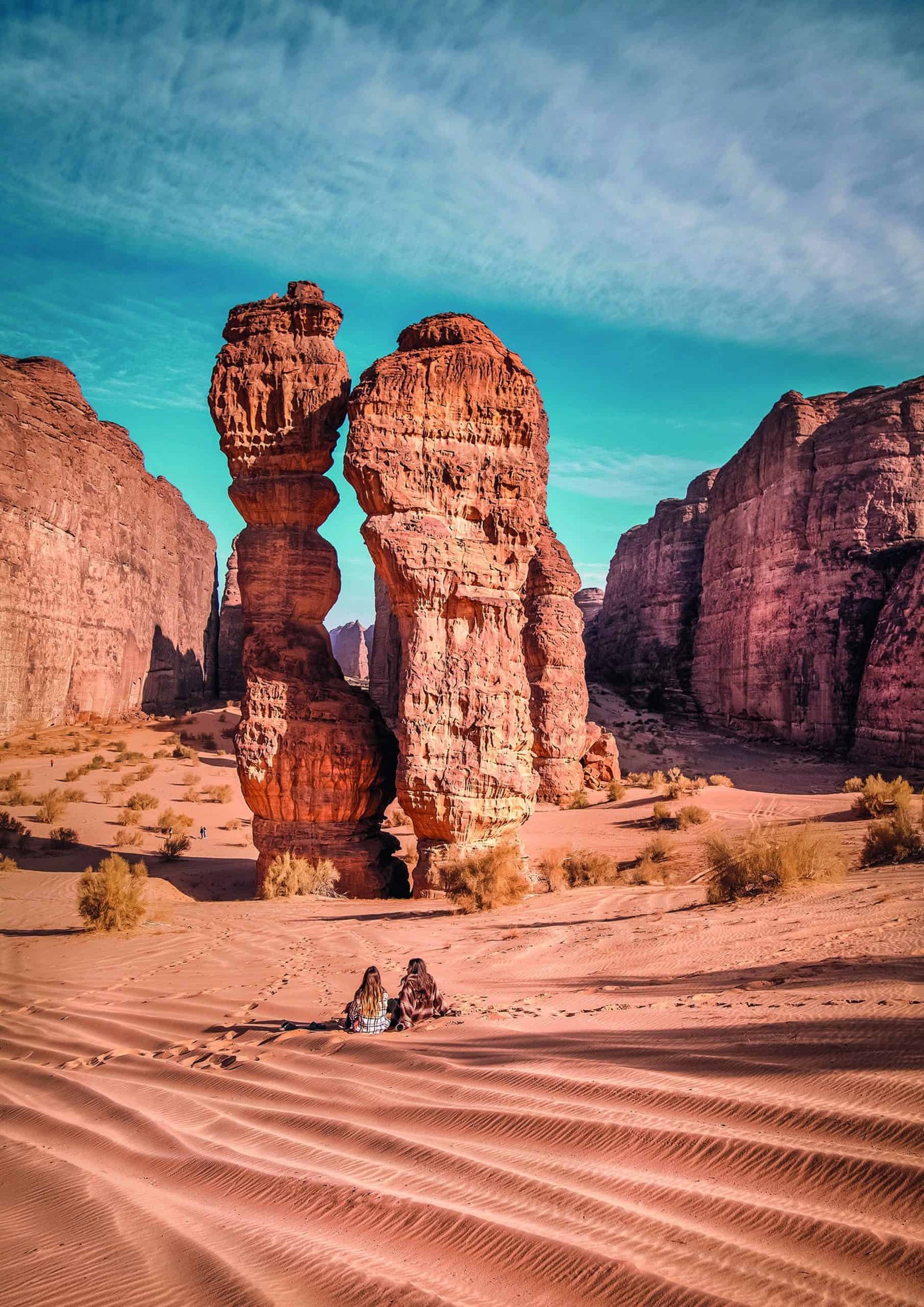 A person is sitting in the sand of a magical desert.
