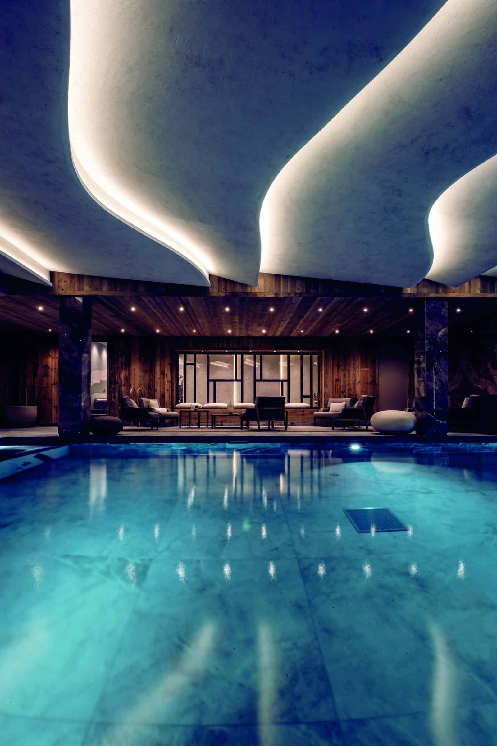 A modern building housing a large indoor swimming pool.