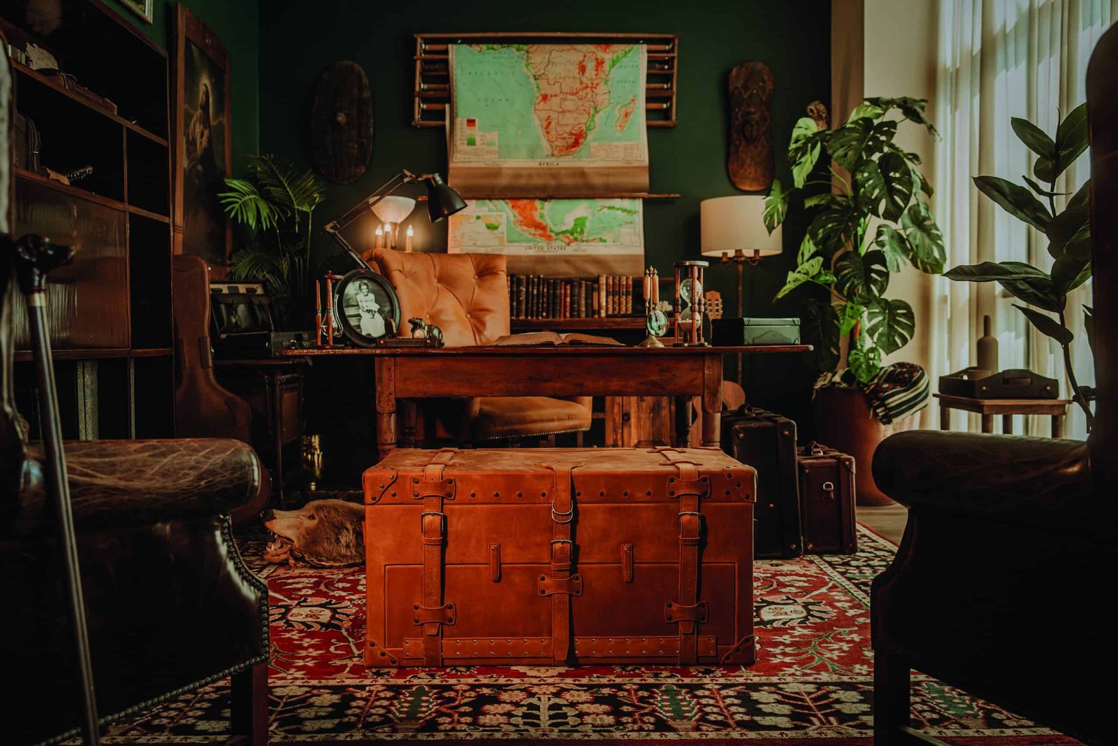 A room with a desk, chairs and a trunk is fully equipped for work and storage. Whether you need to complete assignments or organize your belongings, this space has everything you need for productivity and organization.
