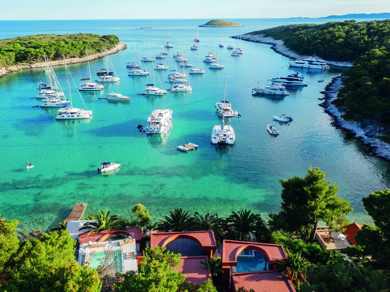 A pearl-like boat docked in the Adriatic bay in Croatia.