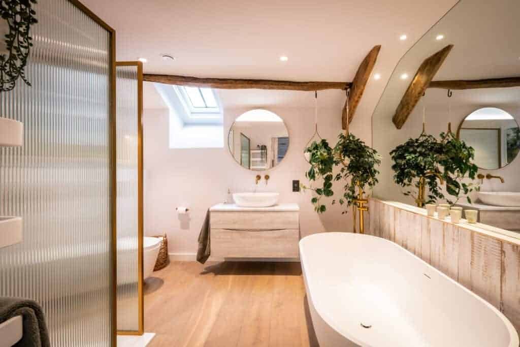 A nature-inspired bathroom with a wooden floor in a cozy home.