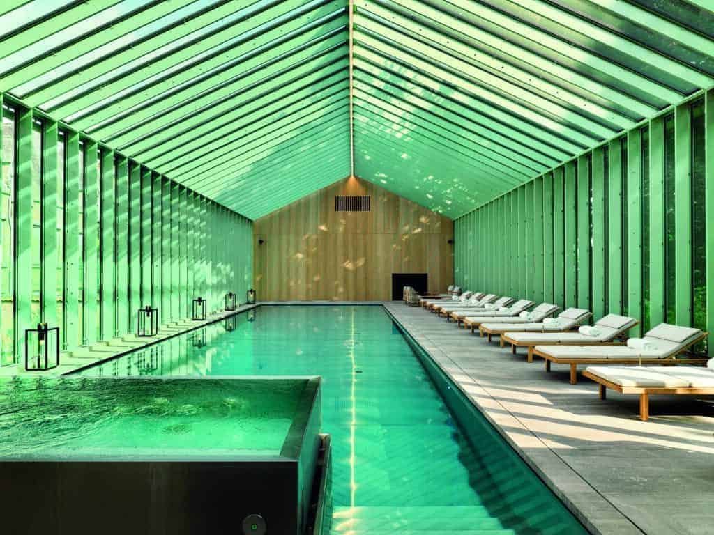 Behold a building with a green roof and a swimming pool.
