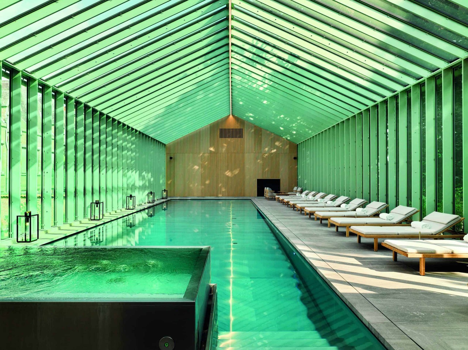 Behold a building with a green roof and a swimming pool.