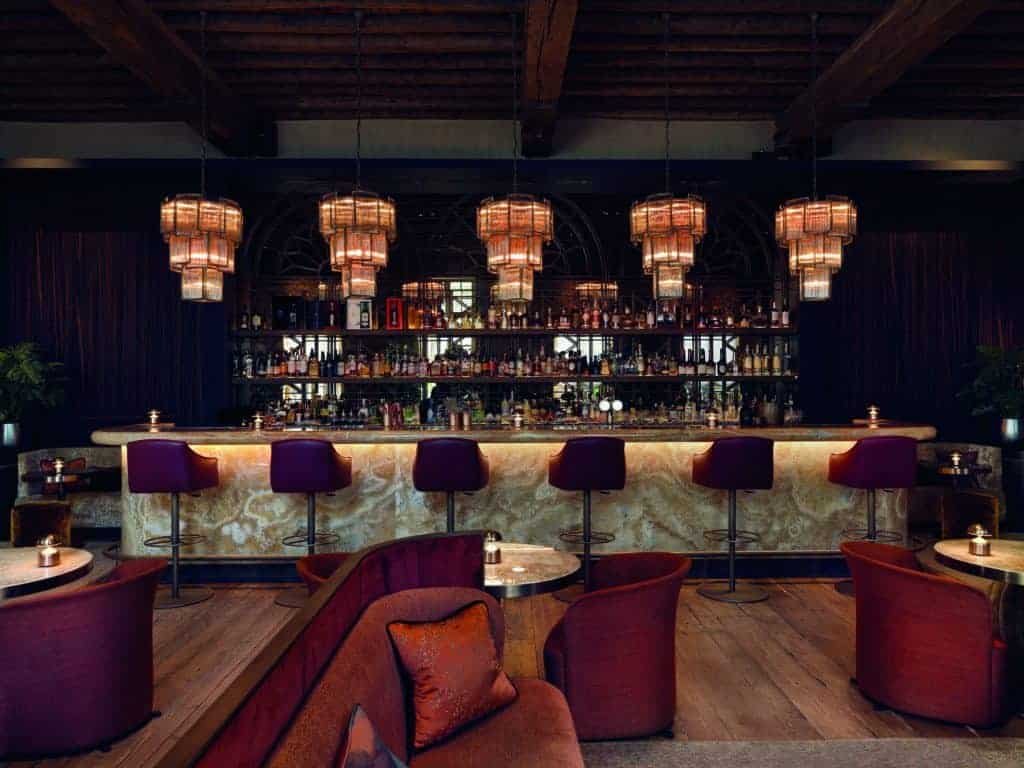 Behold the charming bar nestled within a luxurious hotel, showcasing captivating sites.