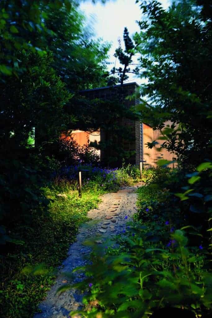 Creating an eco-friendly pathway to a house nestled in the woods.