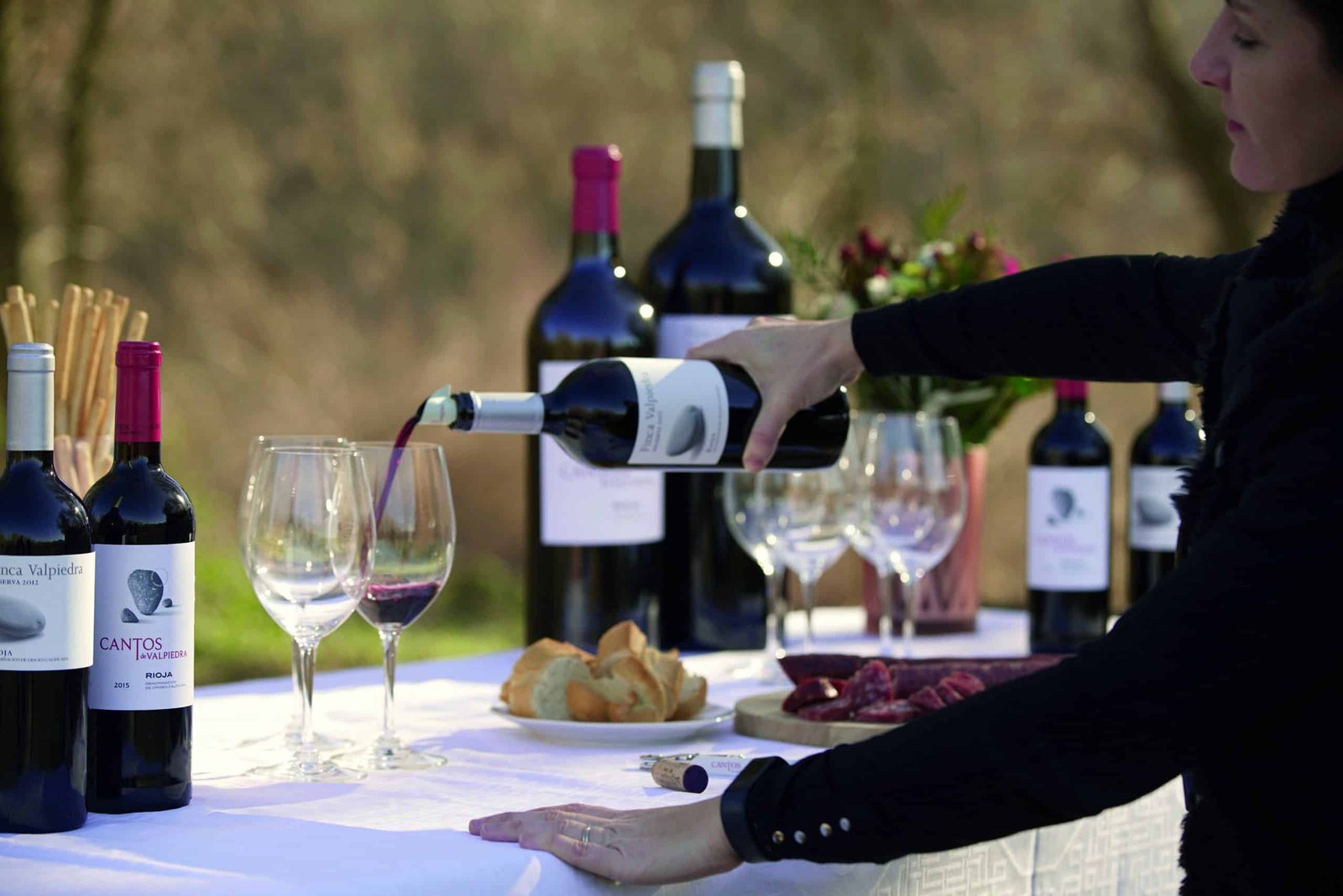 The best wine from a specific region being poured into a glass by a woman.