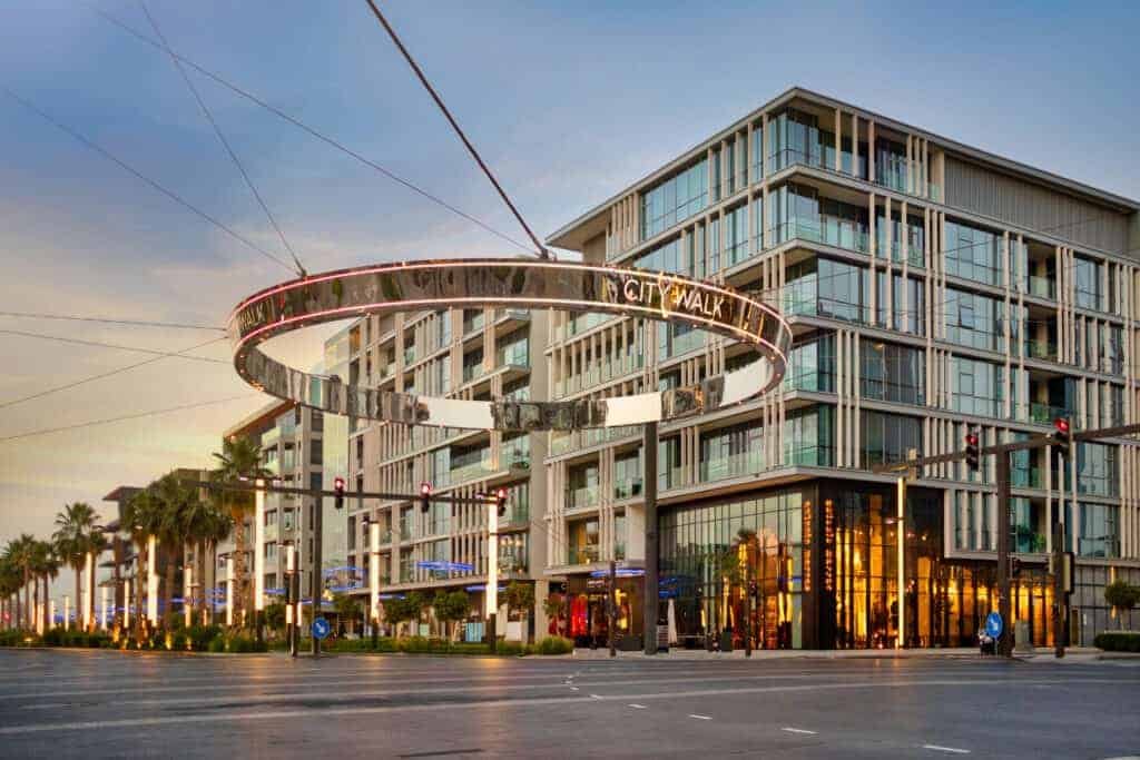 A lavish building with a circular ring in front of it.