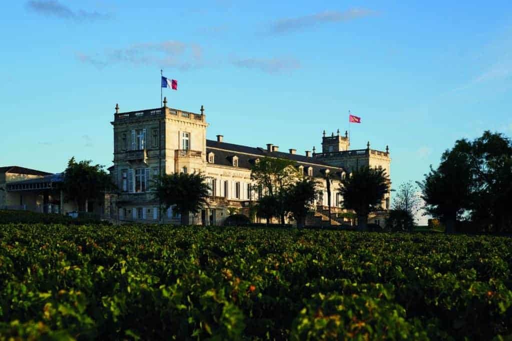 A majestic building nestled amidst an expansive vineyard in the heart of Médoc.