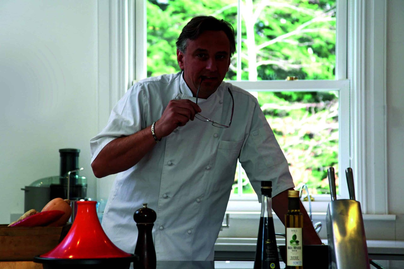 A successful man, wearing a white chef's hat, mastering his secret recipe.