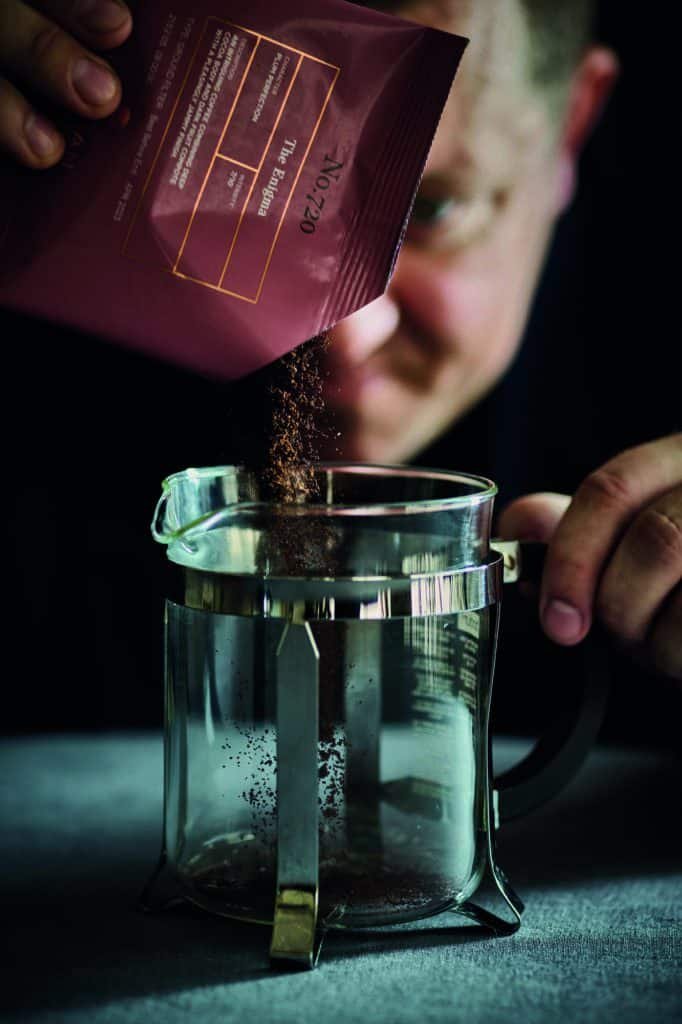 A character pouring coffee into a glass.