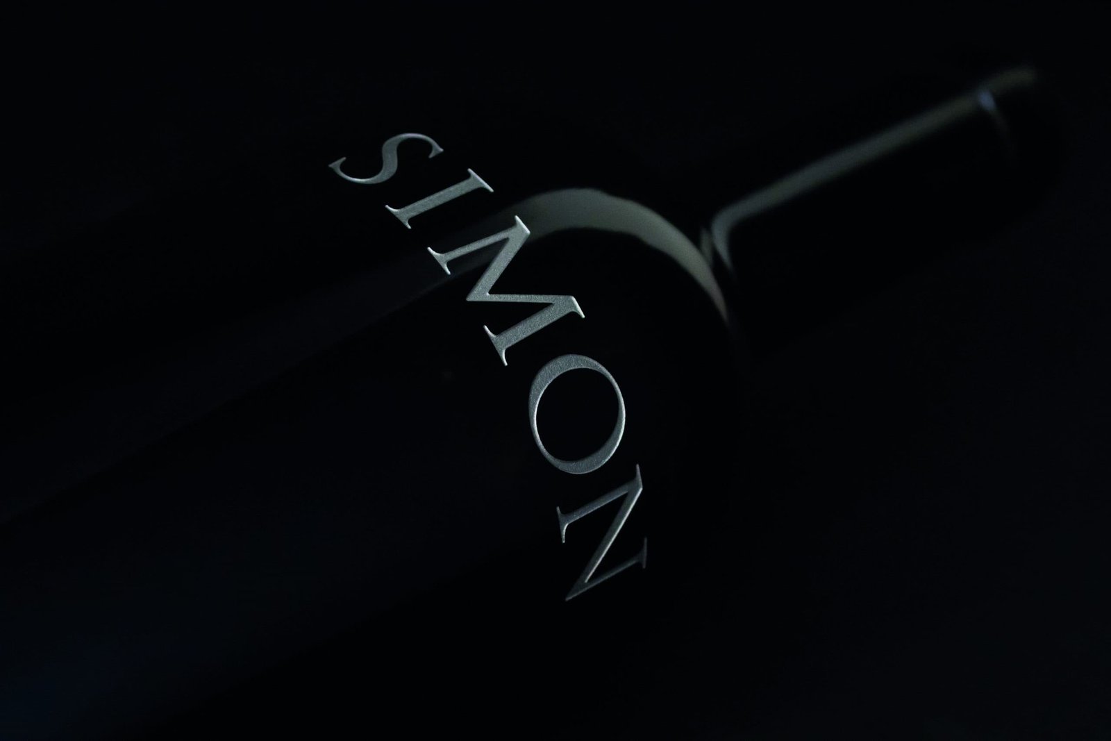 A bottle of wine to share with the word simon on it.