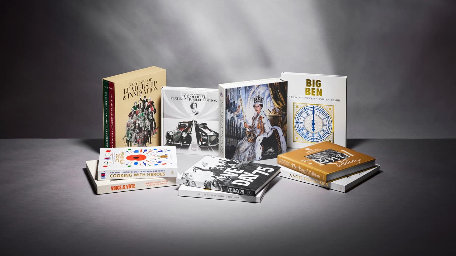 About us: A collection of books on a table with a dark background.