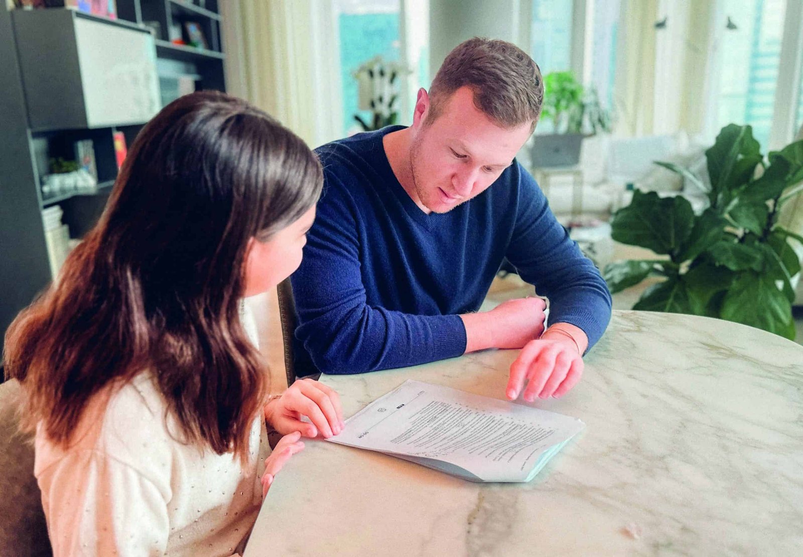 Ivy League experts analyzing a document at a table.