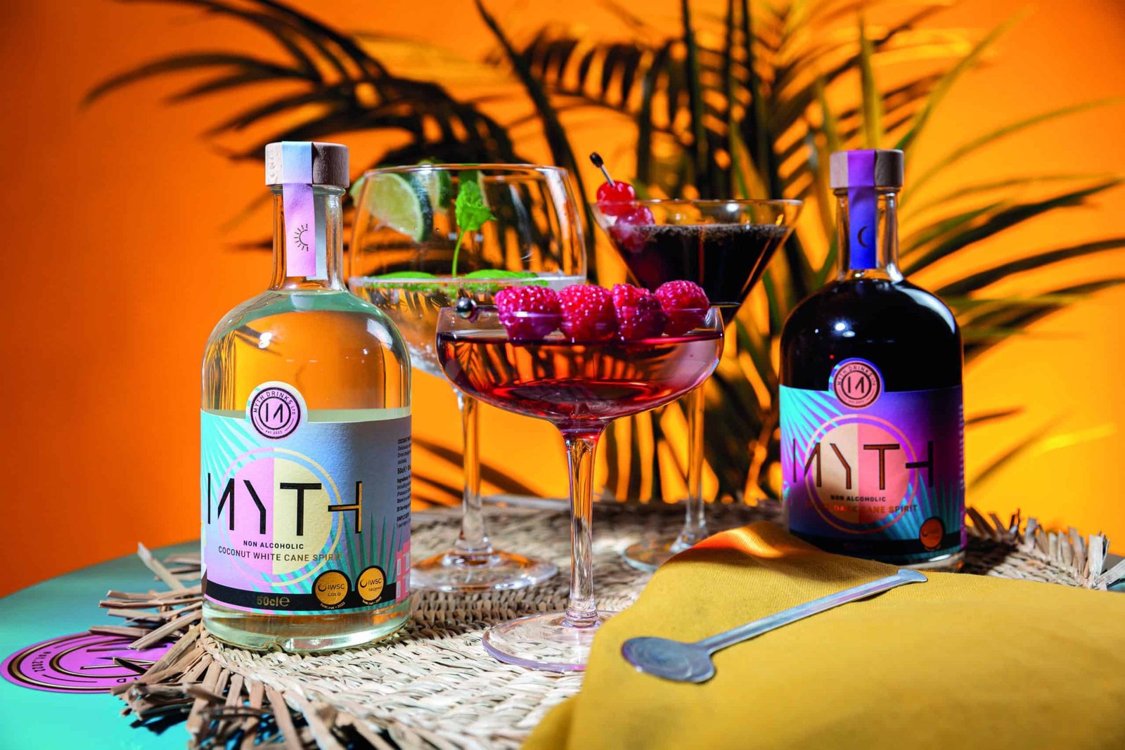 Free spirits toast with a bottle of wine and a bottle of tequila on a table.